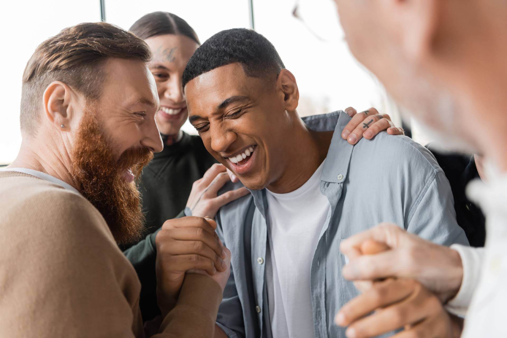 People celebrating a breakthrough in addiction treatment group therapy